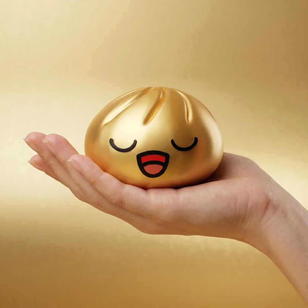 Rare gold dumpling squishy held in hand lifestyle shot