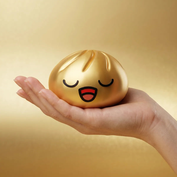 Rare gold dumpling squishy held in hand lifestyle shot