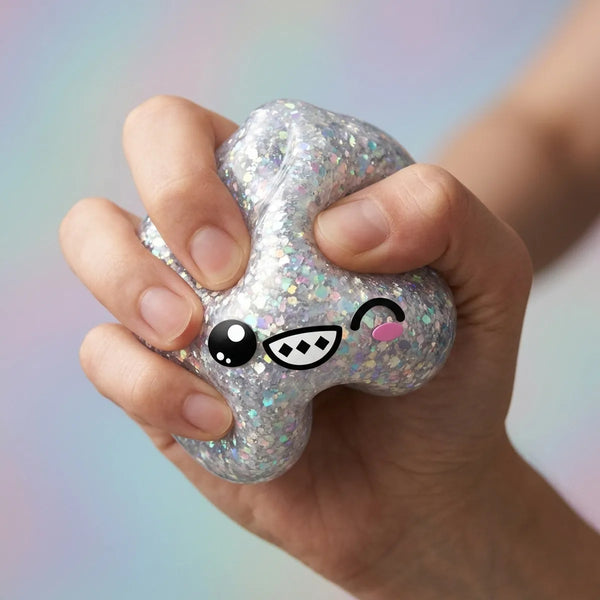 Close-up of fingers pressing the rare silver dumpling squishy