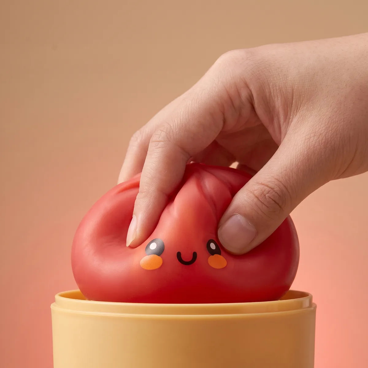 Red dumpling squishy bun squished to show its slow-rise foam
