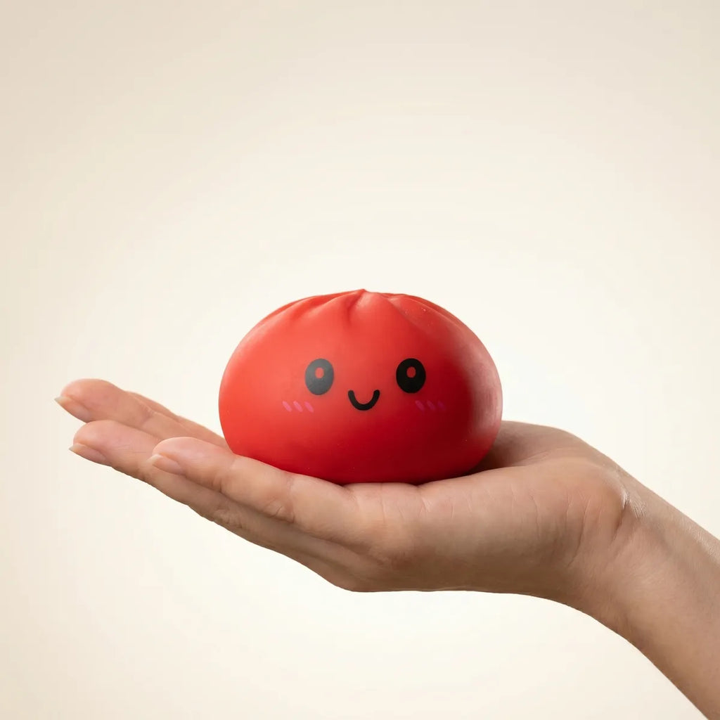 Red dumpling squishy held in hand lifestyle shot