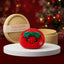 Festive Ribbon Bow Dumpling Squishy Plush on a white studio podium beside a steamer basket