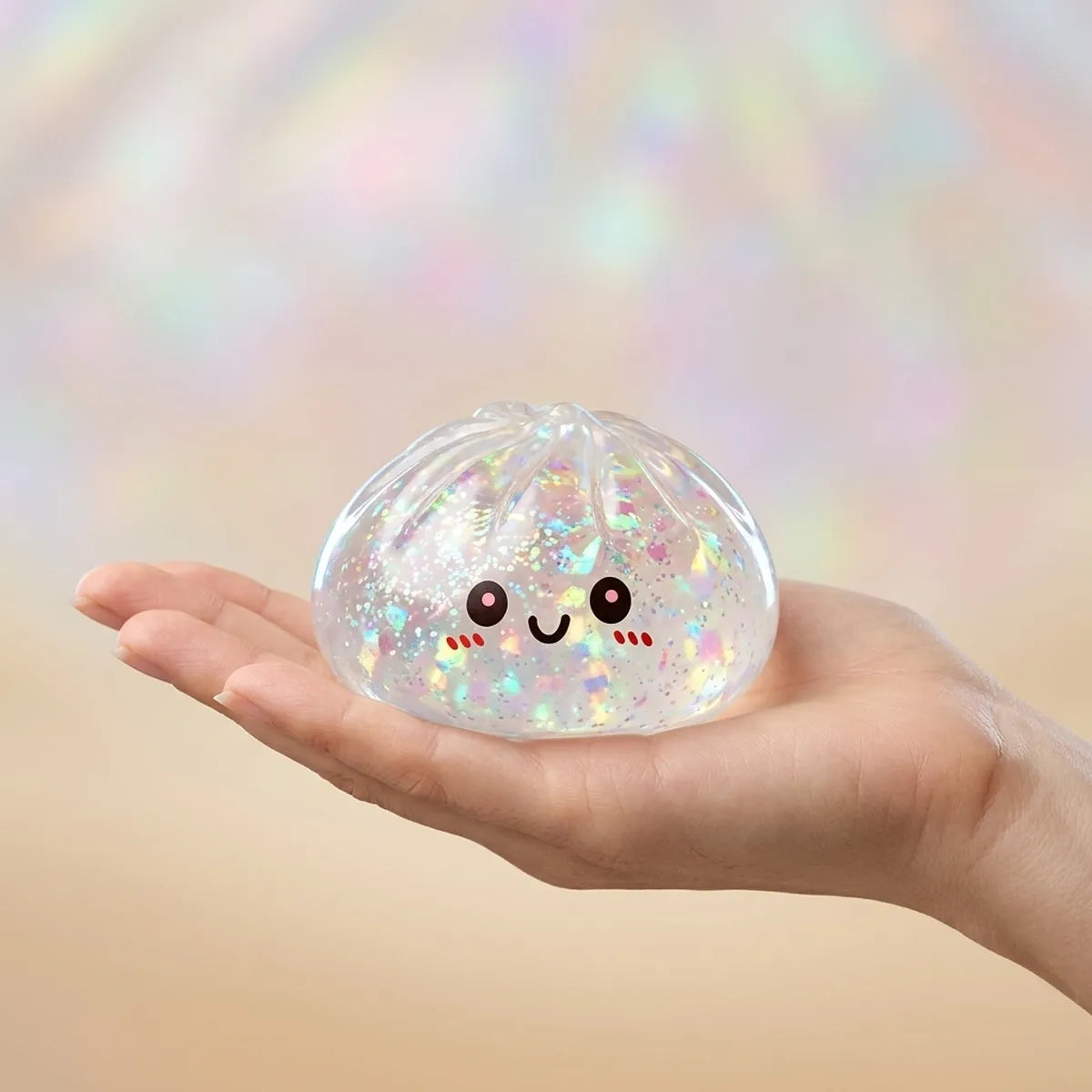 Hand holding a shiny silver glitter dumpling squishy