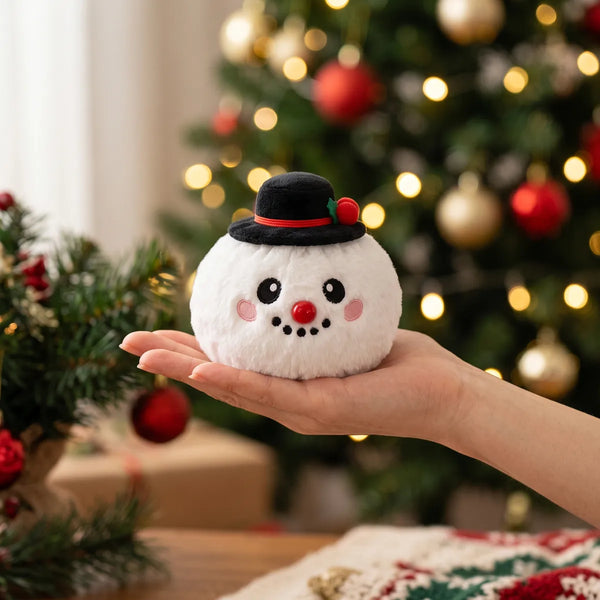 Dapper Snow Hat Dumpling Squishy Plush resting on an open palm to show its real size