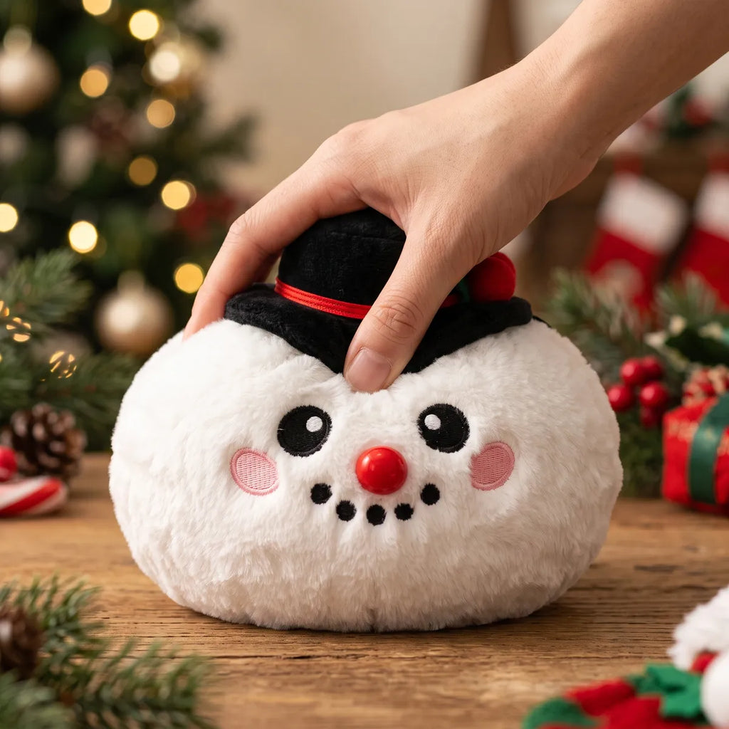 Hand pressing down on the soft Dapper Snow Hat Dumpling Squishy Plush