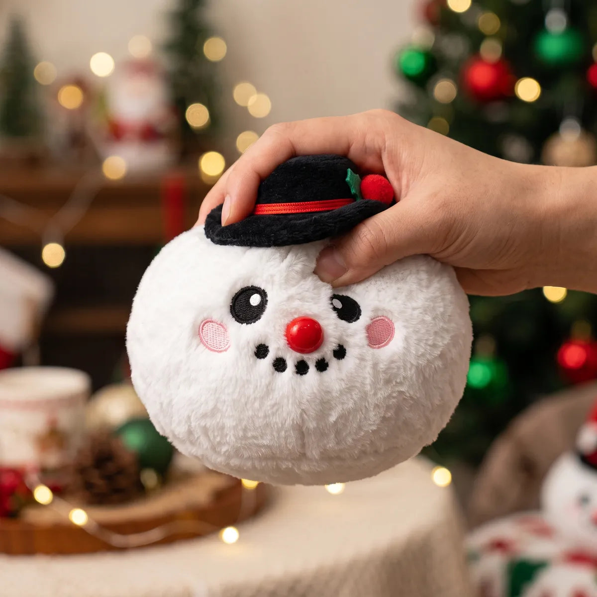 Hand squeezing the Dapper Snow Hat Dumpling Squishy Plush