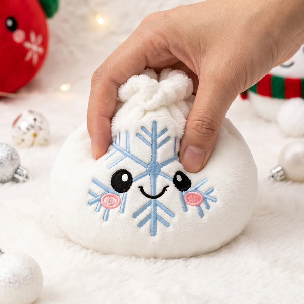 Hand pressing down on the soft Winter Snowflake Dumpling Squishy Plush