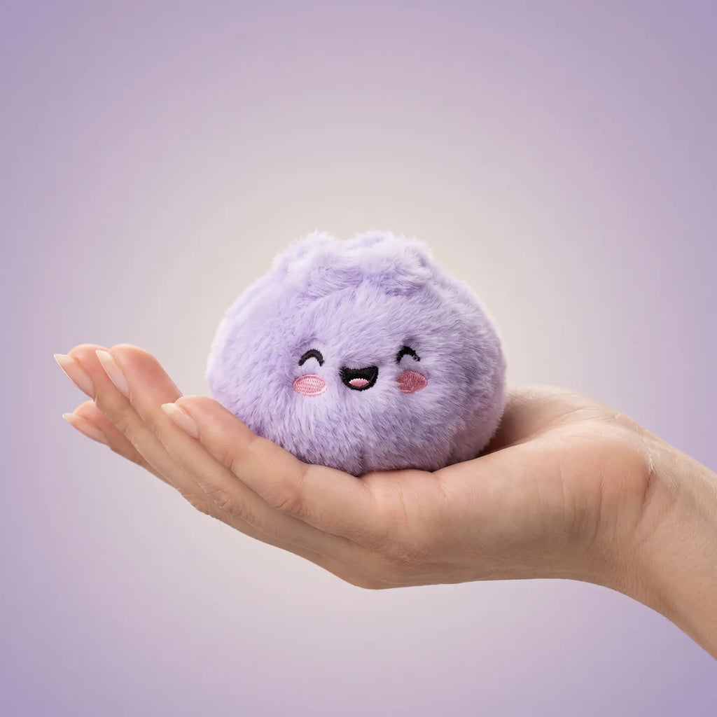 Stuffed animals dumpling squishy mystery held in hand lifestyle shot