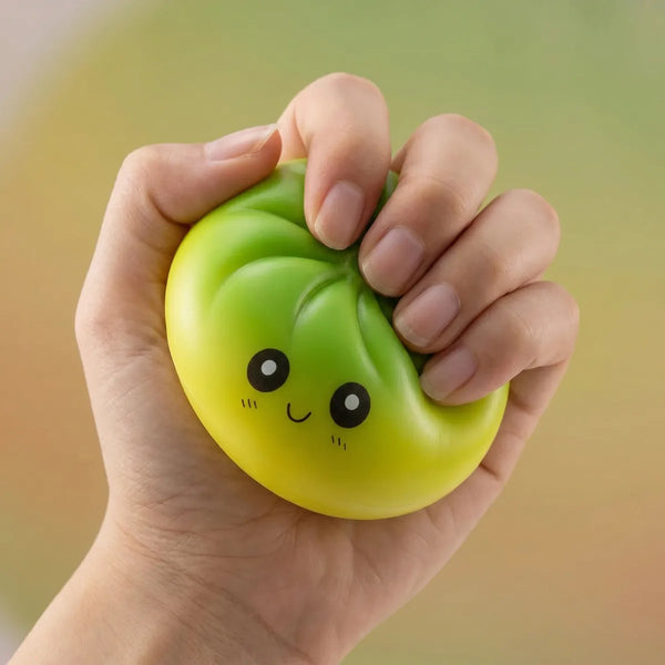 Hands playing with the viral mystery dumpling squishy