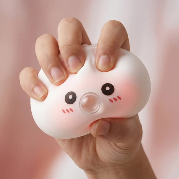 White blow dumpling squishy being squeezed showing slow rising foam