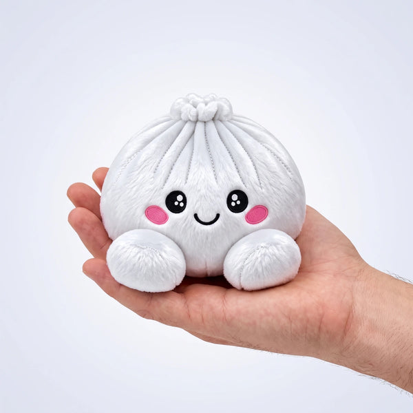 Marshmallow White Dumpling Squishy Plush resting on an open palm to show its real size