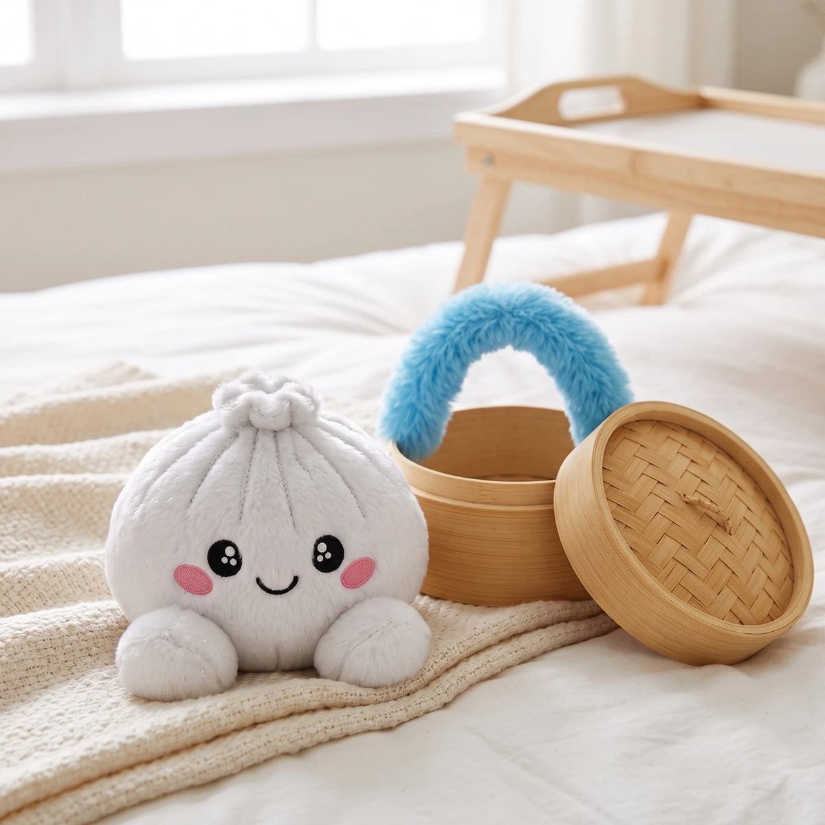 Marshmallow White Dumpling Squishy Plush displayed on a cozy bed next to its open steamer