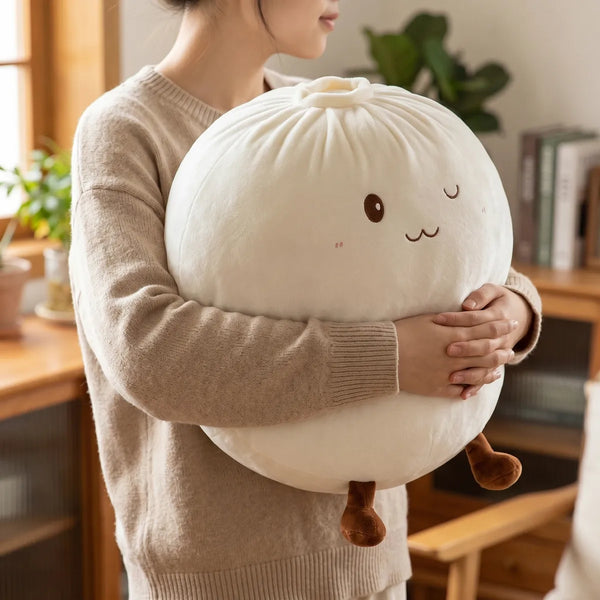 Person hugging the white large dumpling squishy plush pillow