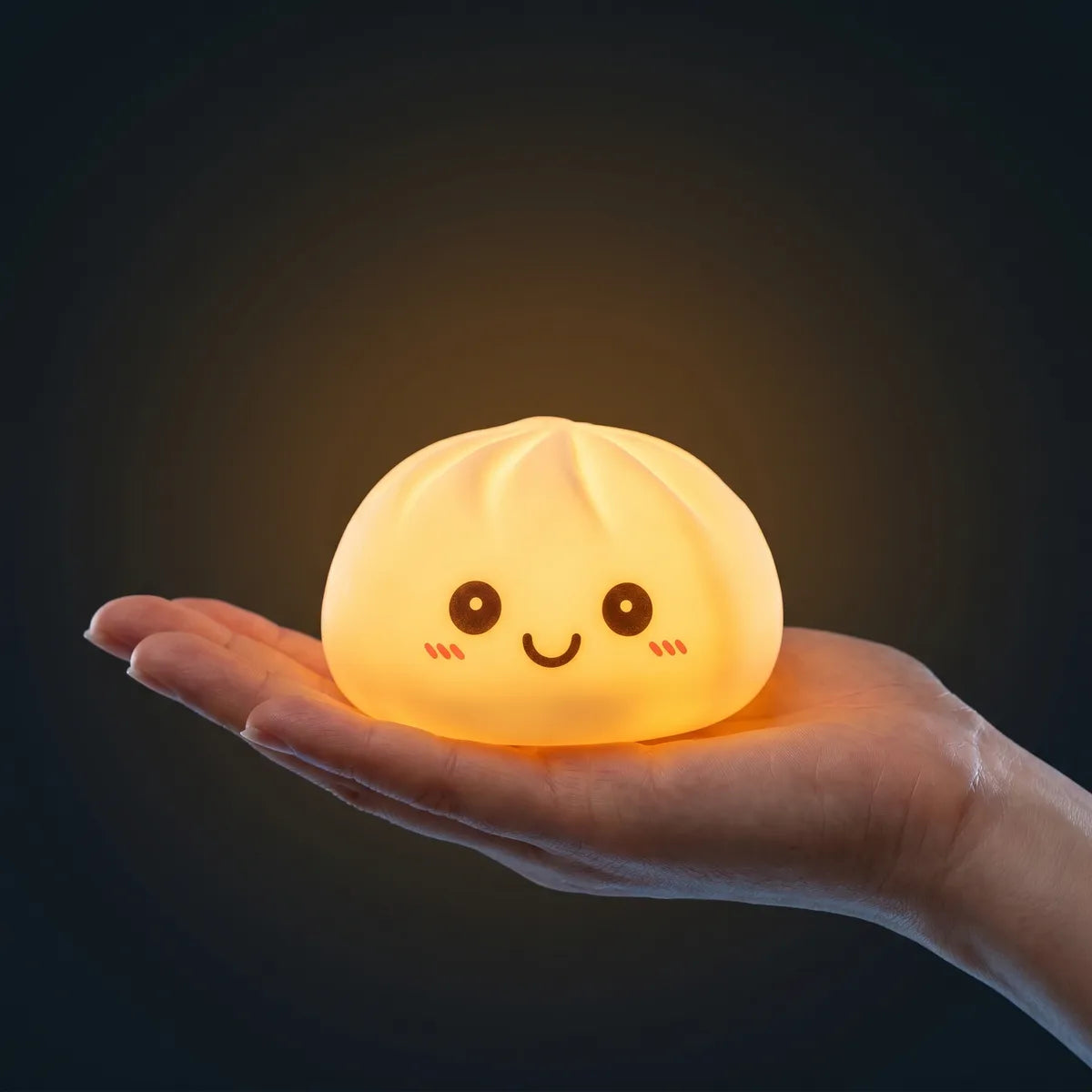 White squishy dumpling light held in hand