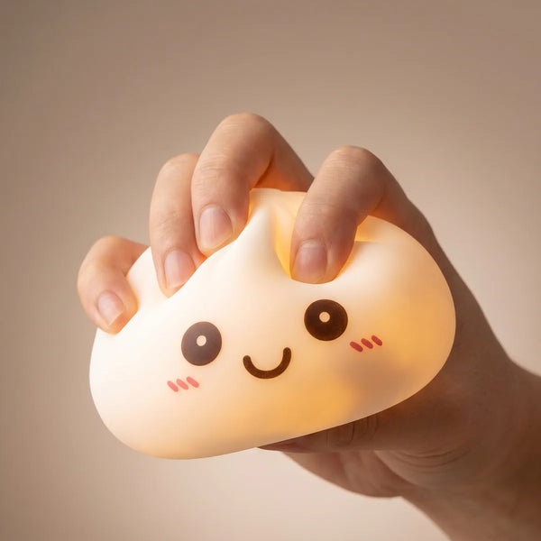 Hands playing with the white squishy dumpling light