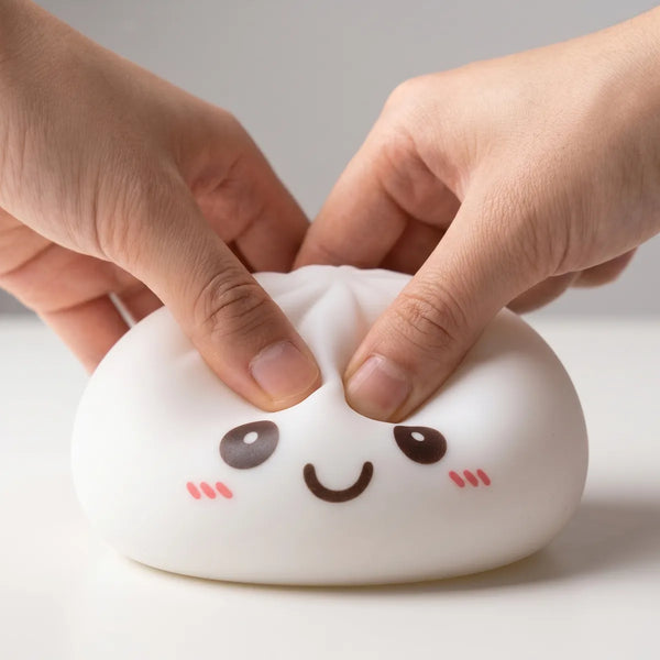 White squishy dumpling light being squeezed showing slow rising foam