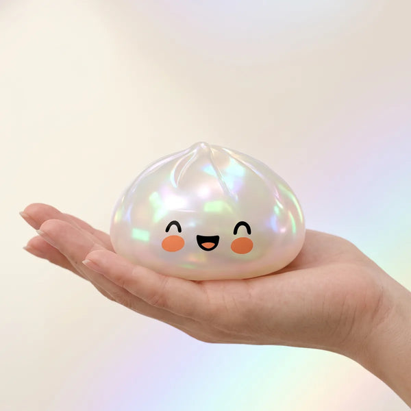 Hand holding a white unique dumpling squishy