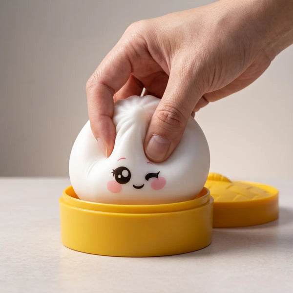 Hand squeezing the Milky White Wink Dumpling Squishy