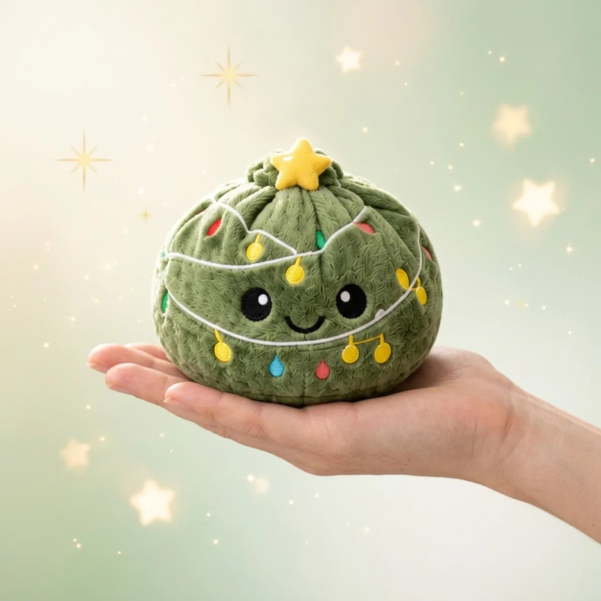 Twinkle Xmas Tree Dumpling Squishy Plush resting on an open palm to show its real size