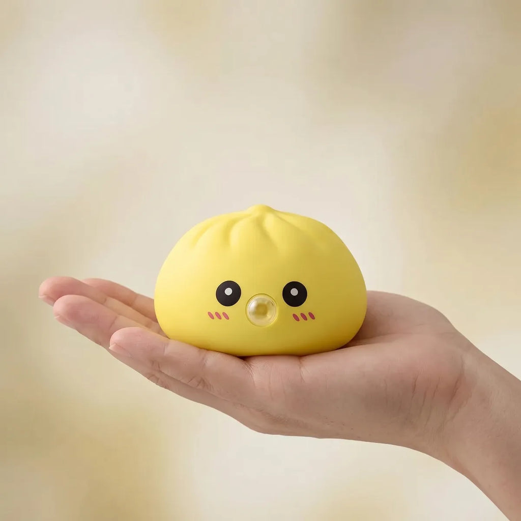 Yellow blow dumpling squishy held in hand