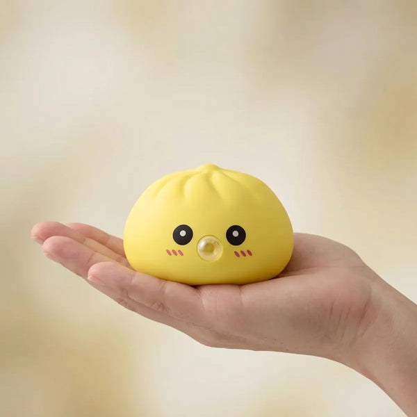 Yellow blow dumpling squishy held in hand