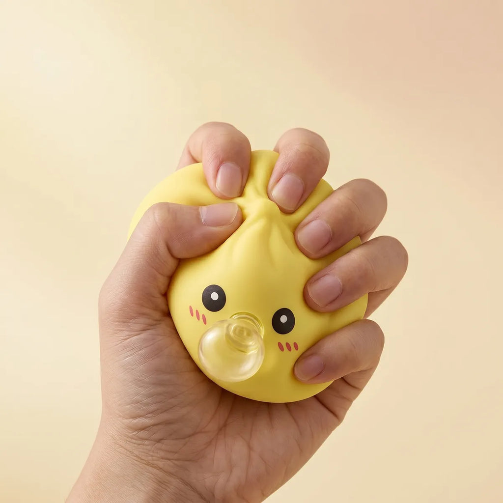Yellow blow dumpling squishy in a playful lifestyle shot