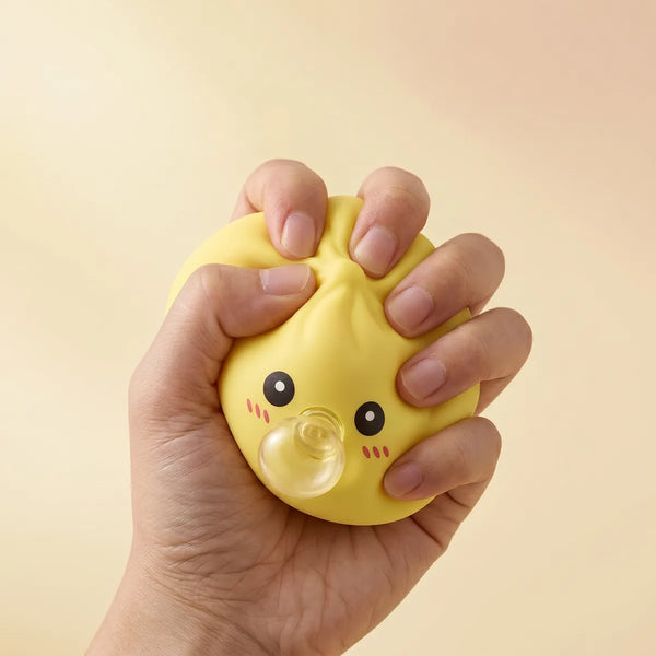 Yellow blow dumpling squishy in a playful lifestyle shot