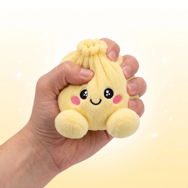 Hand gripping and squishing the Lemon Yellow Dumpling Squishy Plush