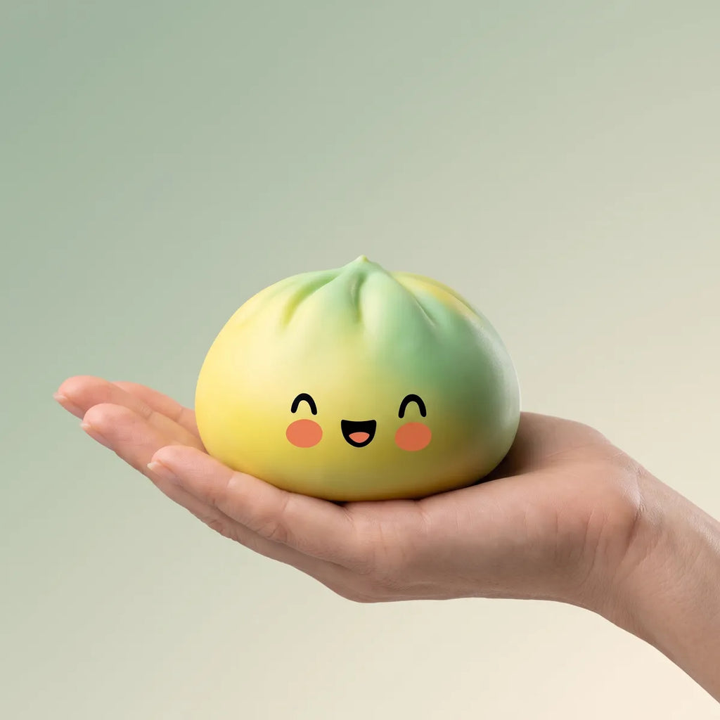 Hand holding a yellow fade dumpling squishy